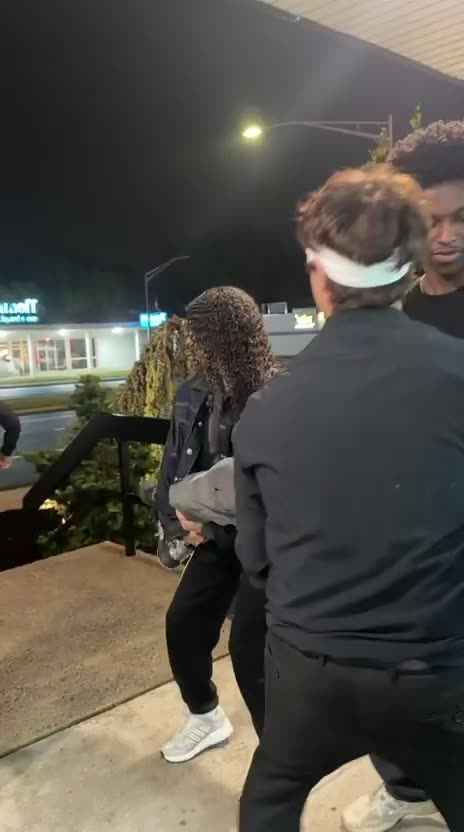 Three Black Arctic Studios actors enjoying burgers together on outdoor steps during a night shoot