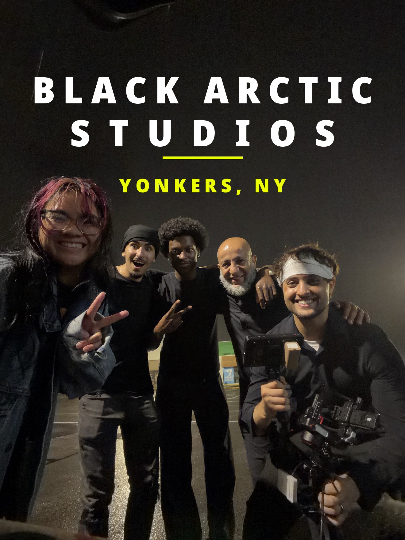 Black Arctic Studios cast and crew together during a night shoot, with a camera rig in the foreground